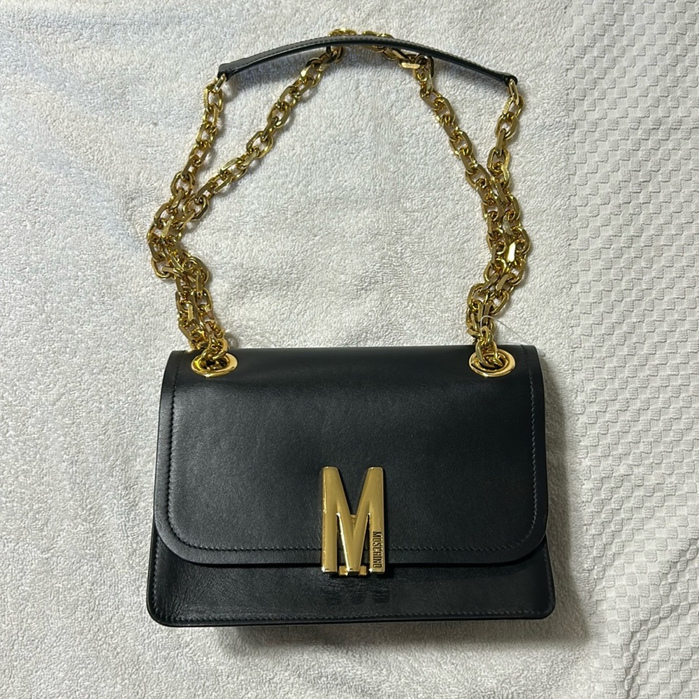 MOSCHINO black leather handbag with gold chain (handle) and gold buckle